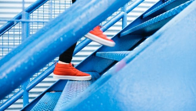 person stepping on blue stairs