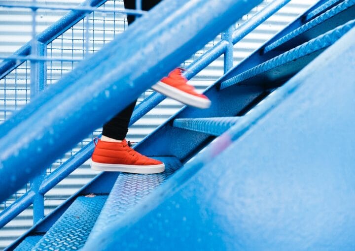 person stepping on blue stairs