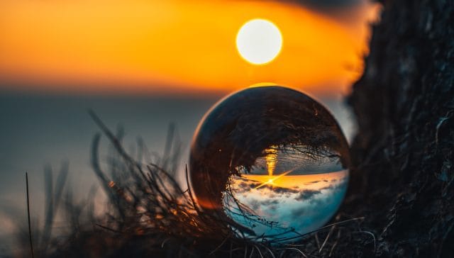 clear glass ball on green grass during sunset