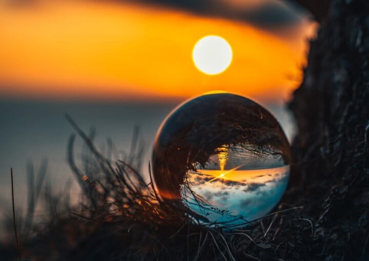 clear glass ball on green grass during sunset